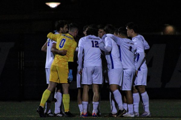 Soccer team huddles before the NE10 Semifinals