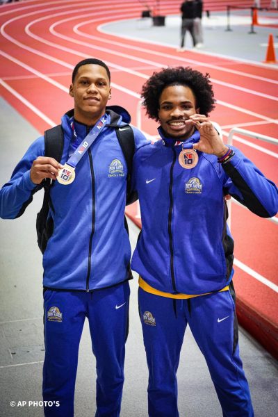 Nile Love and Jordany Dely posing with their medals.