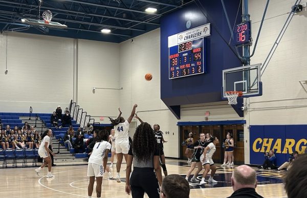 The women’s basketball team competing in the Charger Gymnasium.