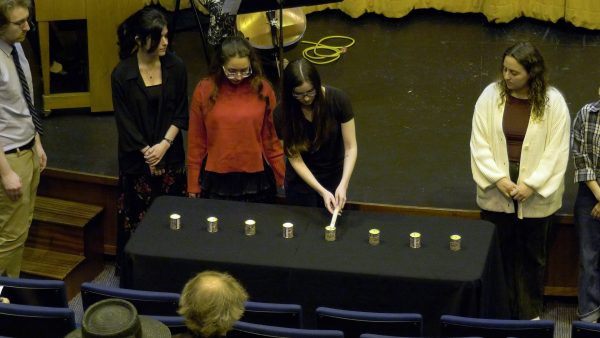 Students lighting candles at the ceremony.

