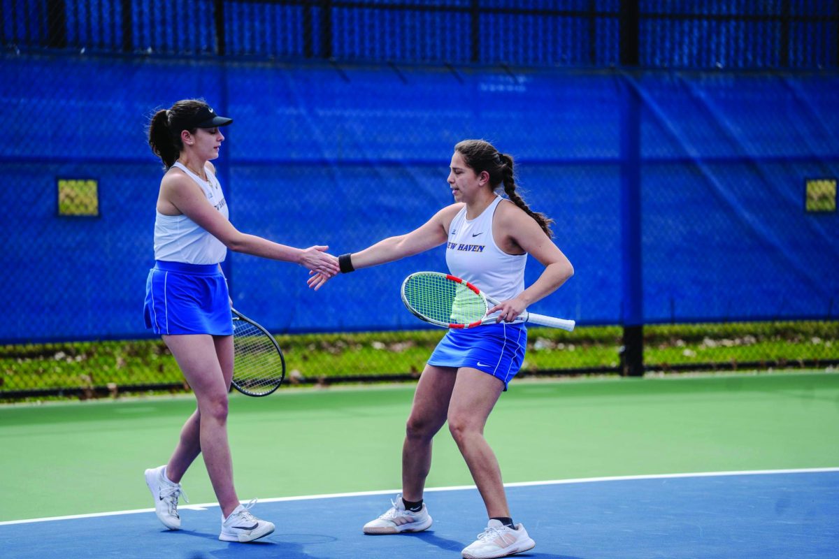 Victoria Togores and Pierina Lescher playing a doubles match. 
